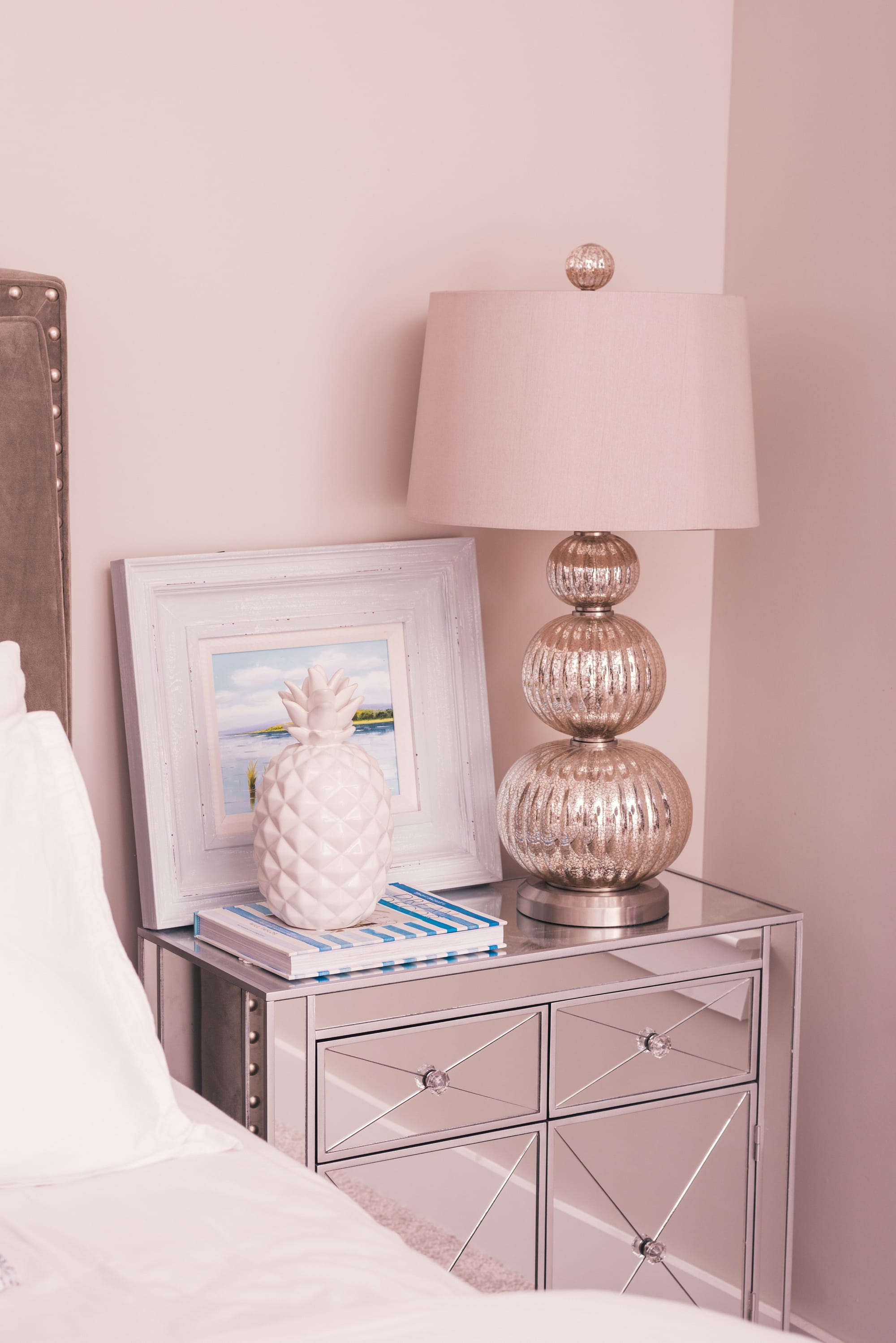 A metal bedside table and a funky lamp