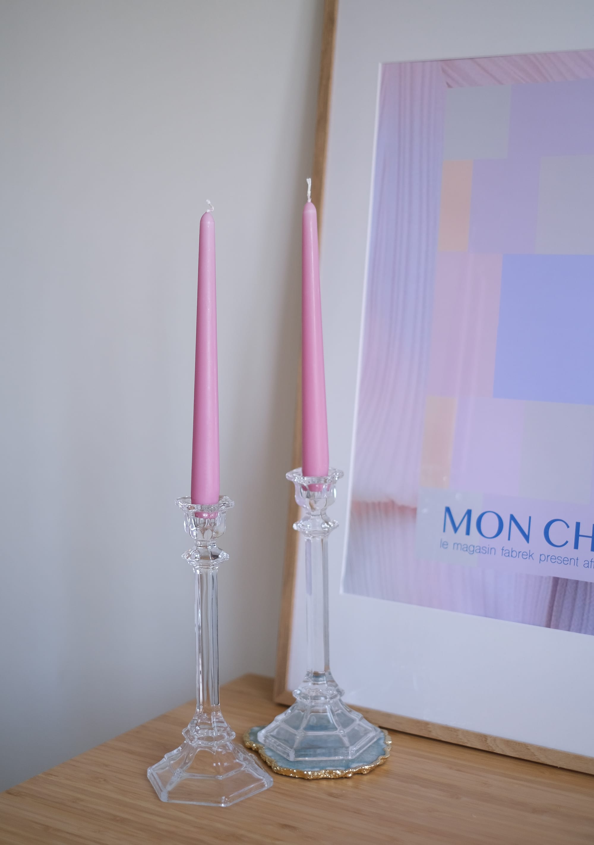 2 pink candles in candle holders