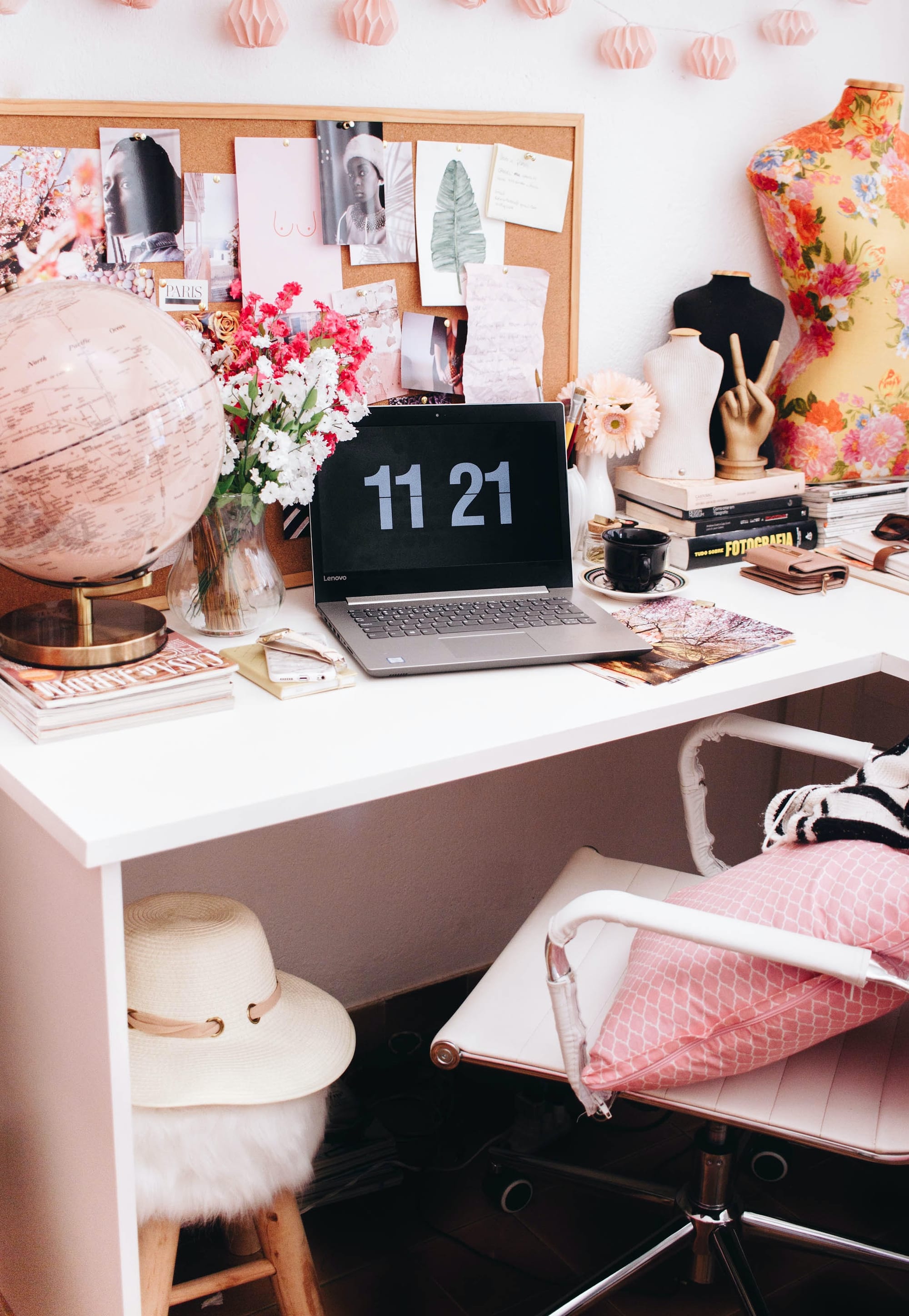 A pink desk with flowers and fluffy accents