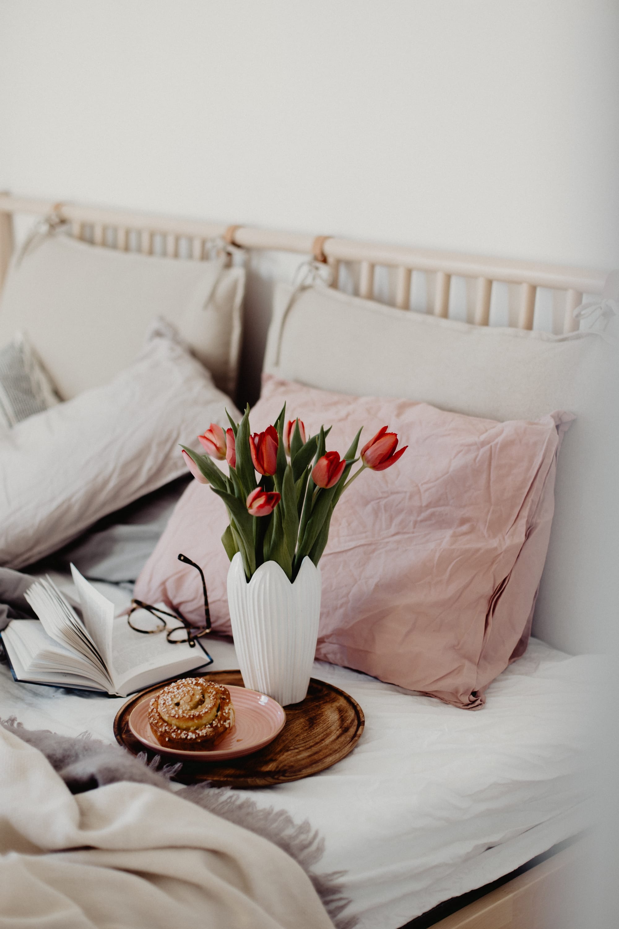 Tulips on a pink and white bed