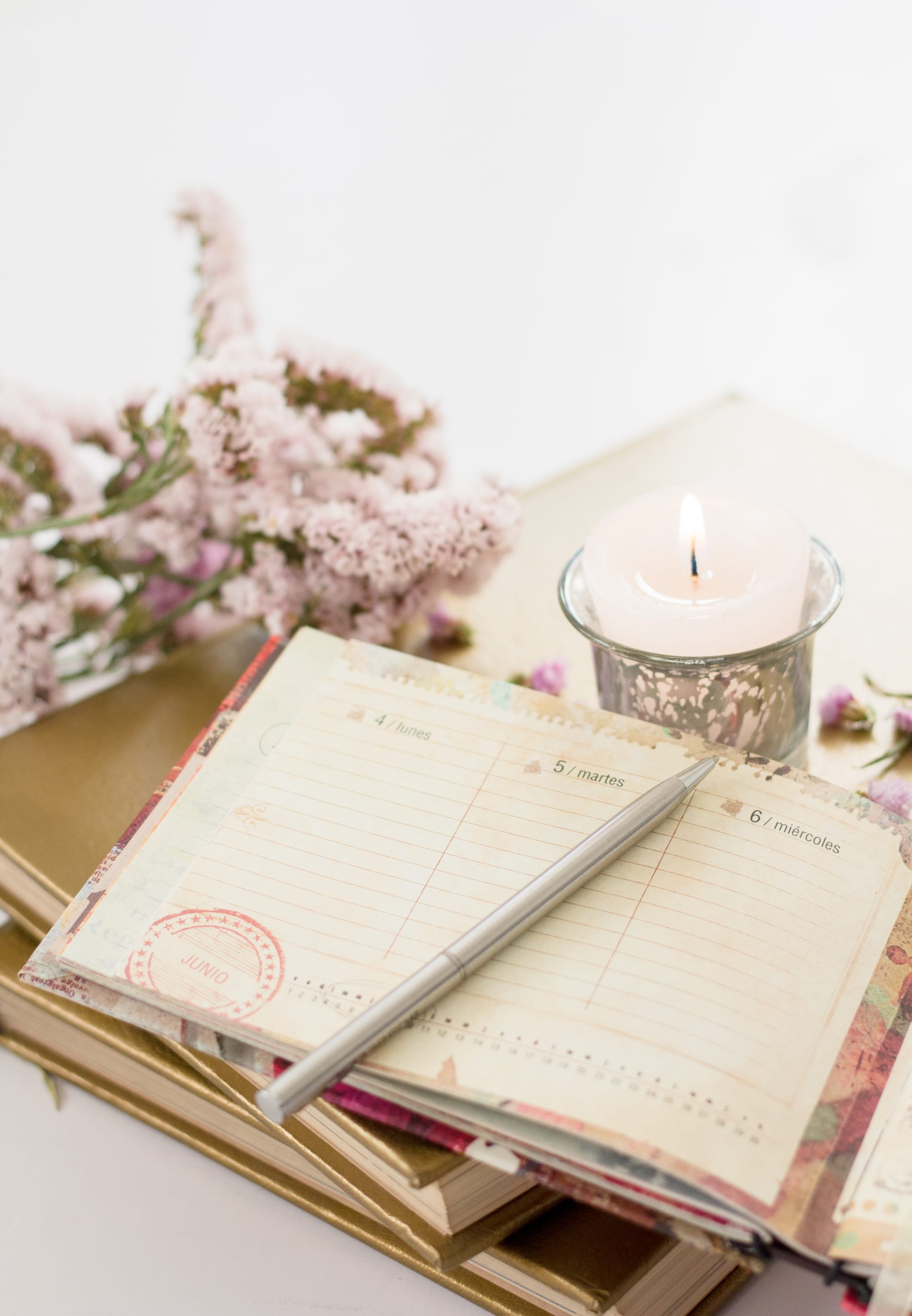 A journal, flowers and candle