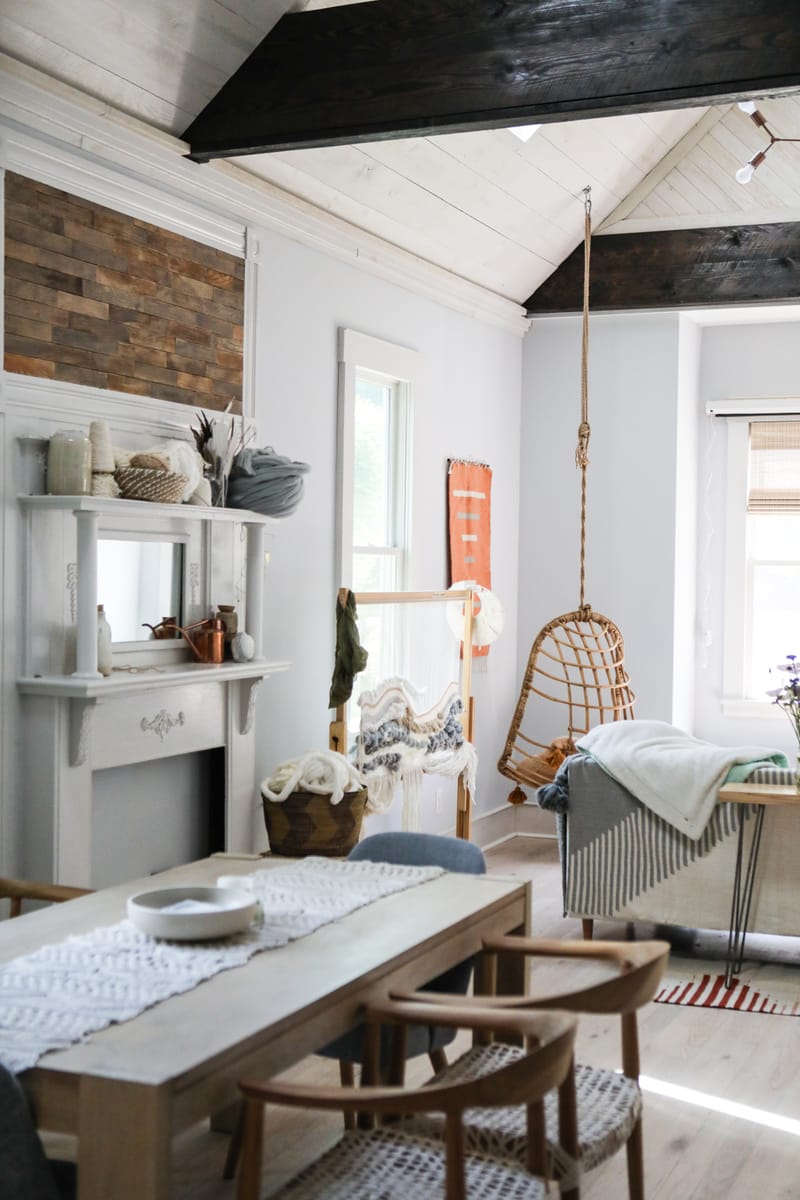 A modern farmhouse decor living room with wooden furniture, patterns, and an egg chair