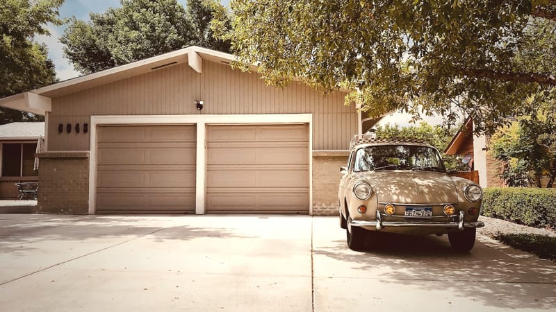 A garage to showcase polyurea floor coating vs epoxy flooring. There is nature and a car in the photo